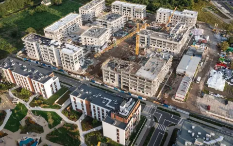 Budowa osiedla mieszkaniowego. Zastanawiasz się, ile kosztuje mieszkanie w Czechach? Tu powstają nowe domy, a krajobraz budowy sugeruje, że ceny mogą być różne.