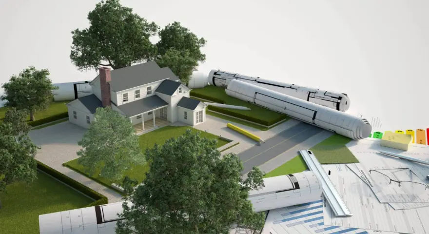 Model domu z planami i materiałami budowlanymi. Część budynku na działce sąsiada, symbolizująca projektowanie i planowanie.