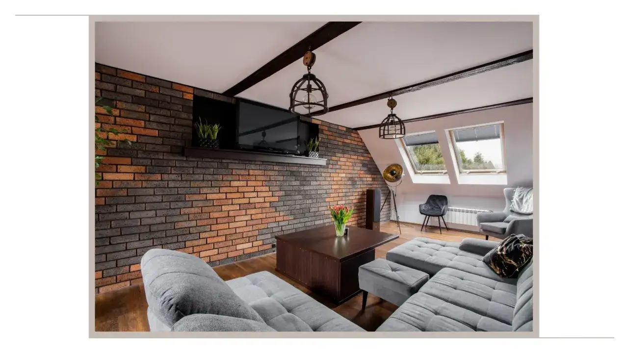 Przytulne mieszkanie w stylu loft z ceglaną ścianą, wygodną szarą kanapą i drewnianym stolikiem.